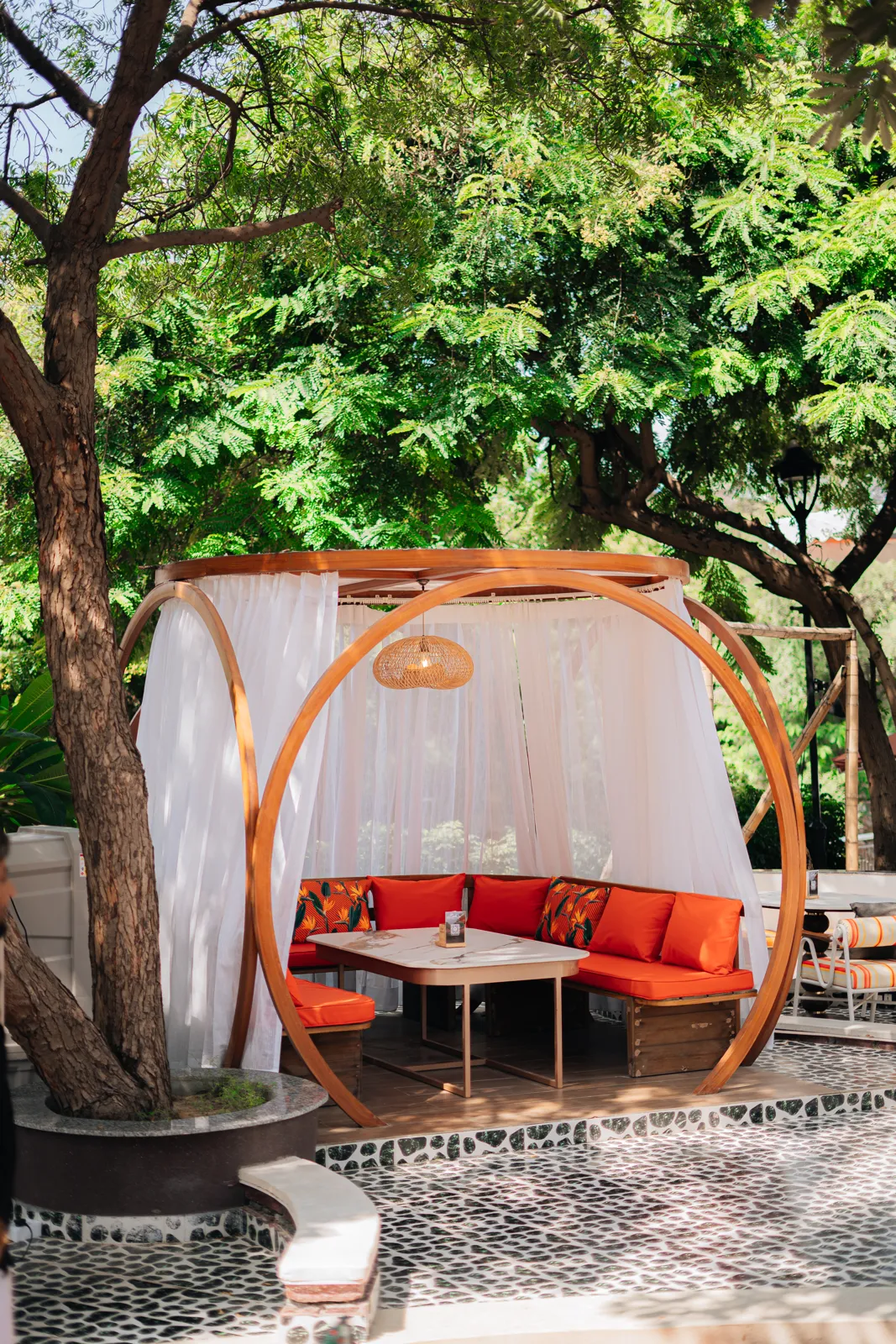 Round daybed cabana under the trees